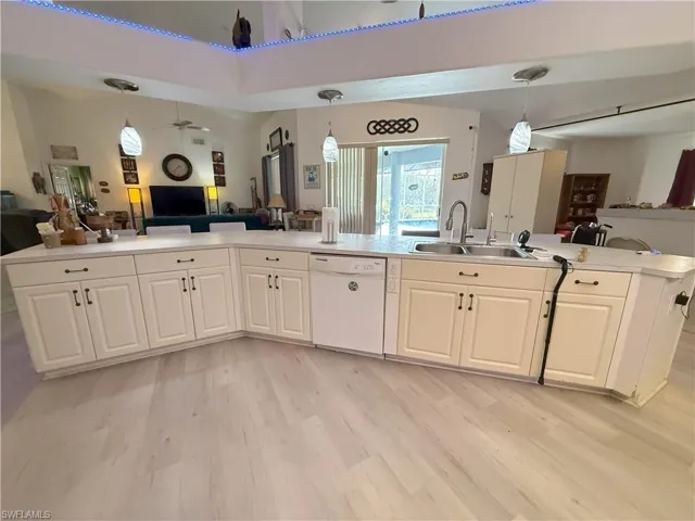 Kitchen featuring dishwasher, hanging light fixtures, and sink