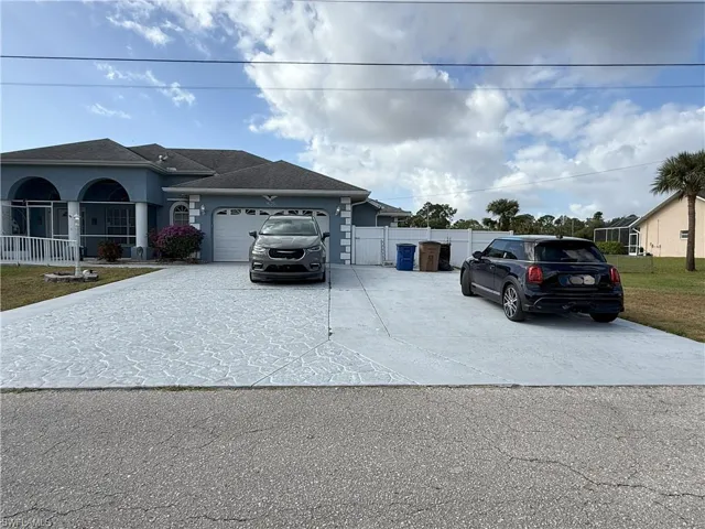 View of front facade featuring a porch and a garage