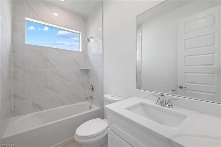 Full bath featuring vanity and shower / bath combination