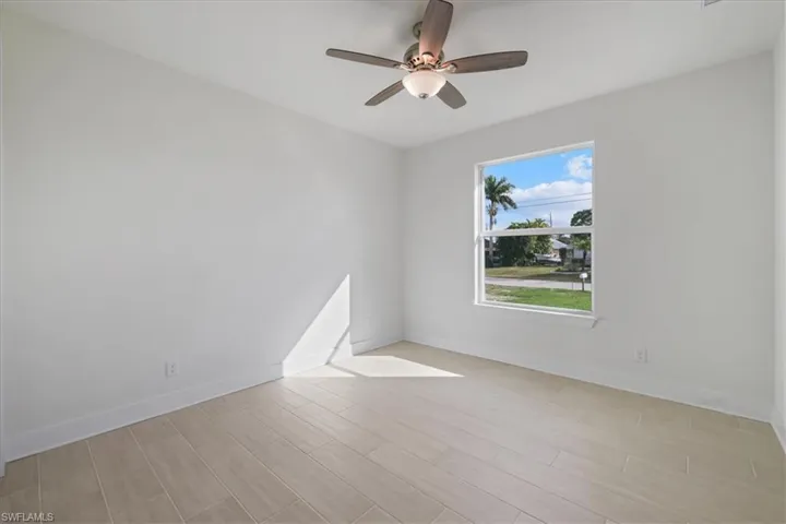 Spare room featuring wood tiled floors and a ceiling fan