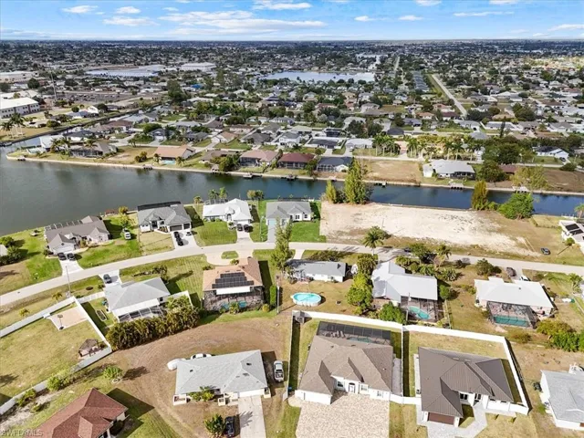 Aerial view of property's location featuring nearby suburban area and a freshwater canals