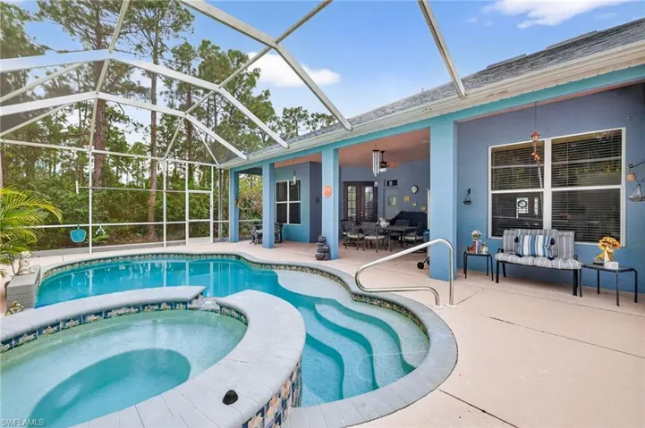 Integrated pool / hot tub with a patio, a sunroom, a lanai, and outdoor lounge area