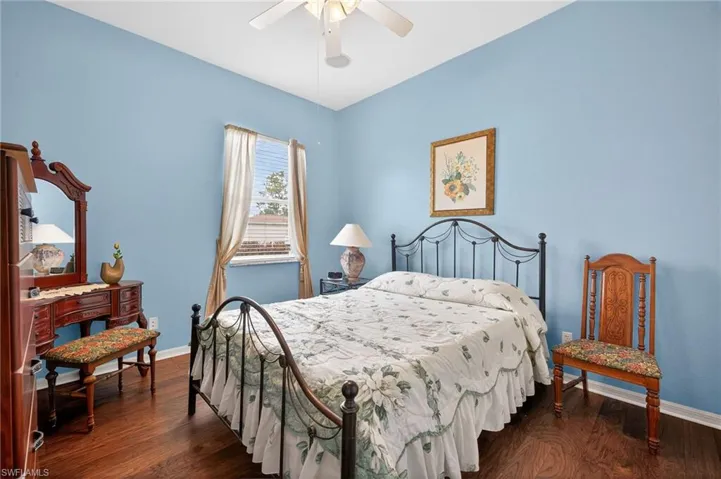 Bedroom featuring dark wood finished floors and ceiling fan