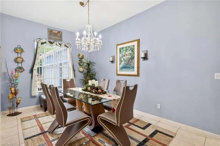 Dining space with hanging lights and light tile patterned floors