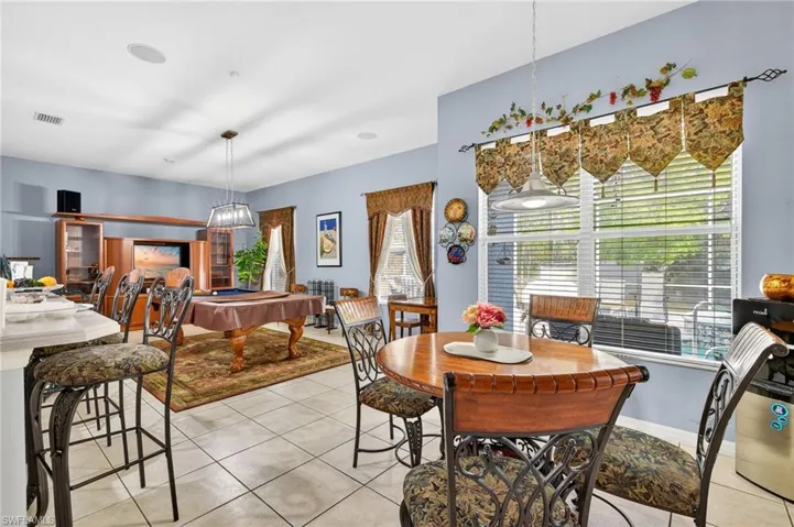 Dining space featuring billiards table and light tile patterned floors