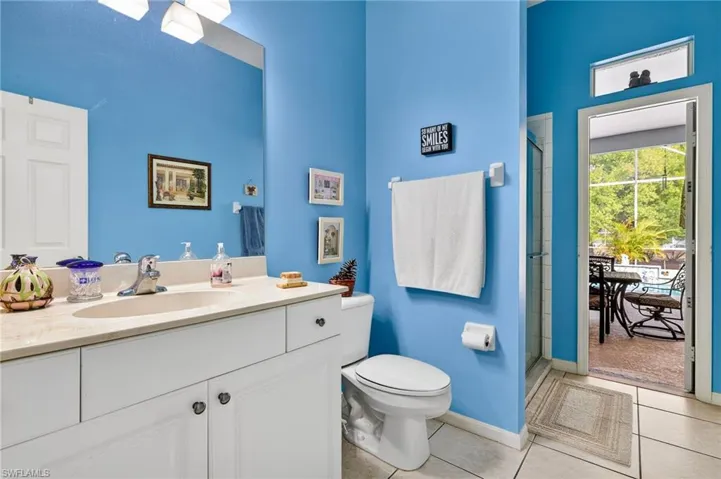Bathroom featuring a stall shower, vanity, and light tile patterned flooring