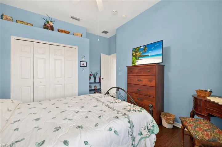 Bedroom featuring dark wood finished floors, a ceiling fan, and a closet