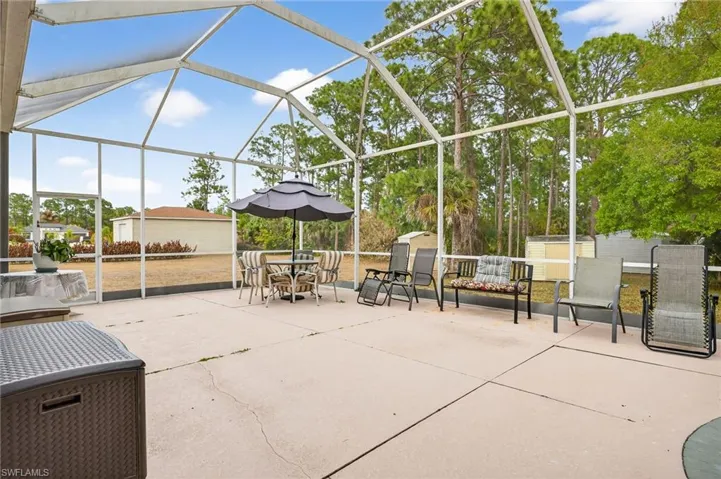 View of patio featuring a storage unit, outdoor dining area, a lanai, and a sunroom