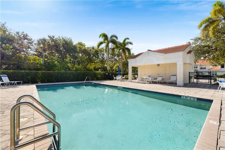Community pool with a patio