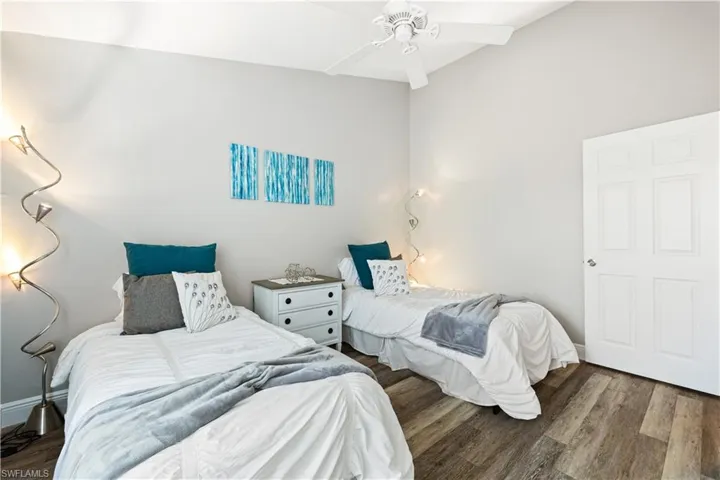 Bedroom featuring wood finished floors and baseboards