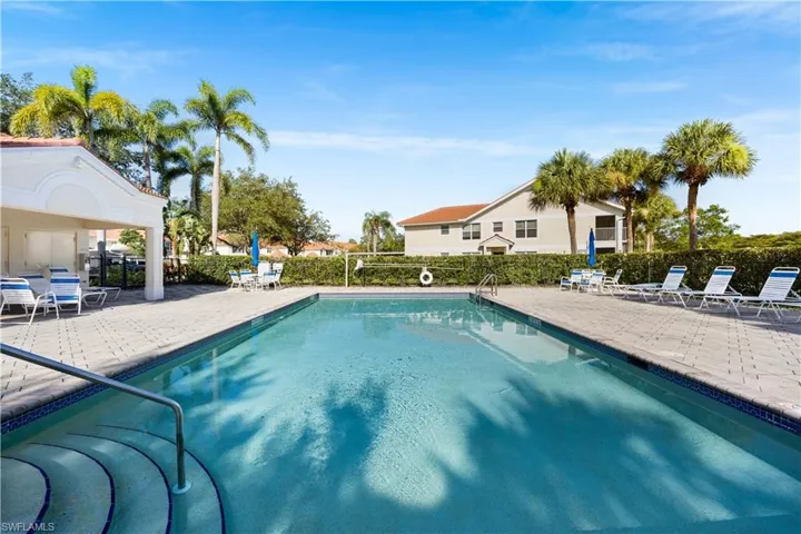 Community pool with a patio