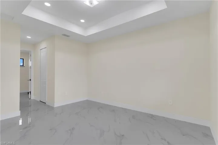 Empty room featuring a raised ceiling