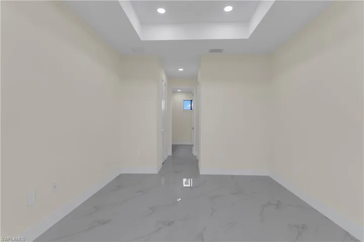 Unfurnished room featuring a tray ceiling