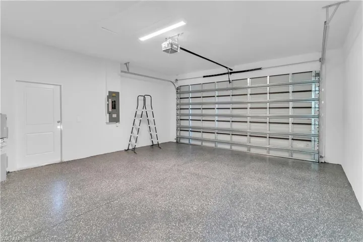 Garage with a garage door opener and electric panel