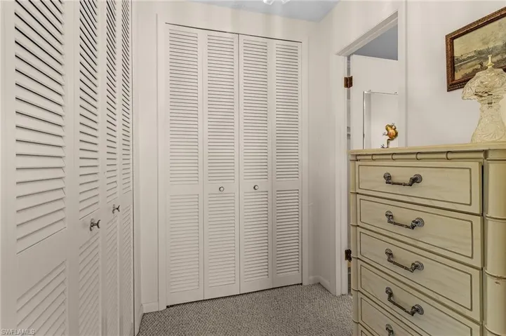 Dressing area has plenty of floor space to accommodate the dresser and access to 2 closets. The area is also defined by a decorative archway.