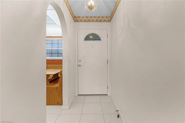 Looking into the foyer and kitchen. The arches separate and define the spaces in such a charming way.