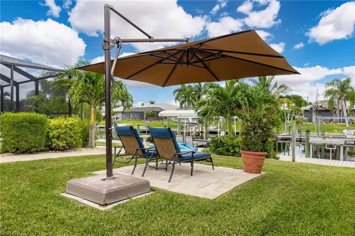 Side yard with a patio area to enjoy the water view.