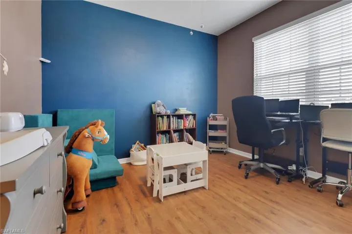 Office space featuring wood finished floors and baseboards