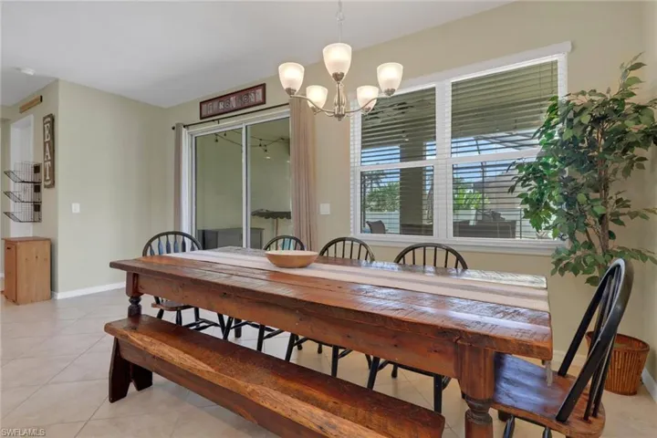 Dining space featuring a chandelier, baseboards, and light tile patterned flooring