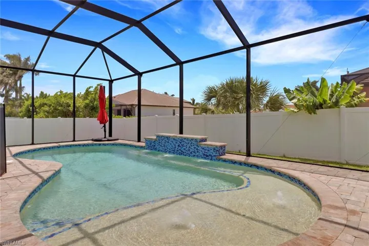 View of swimming pool with a patio, a fenced backyard, and a lanai