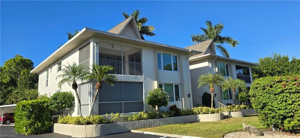 View of front of property featuring stucco siding and a balcony