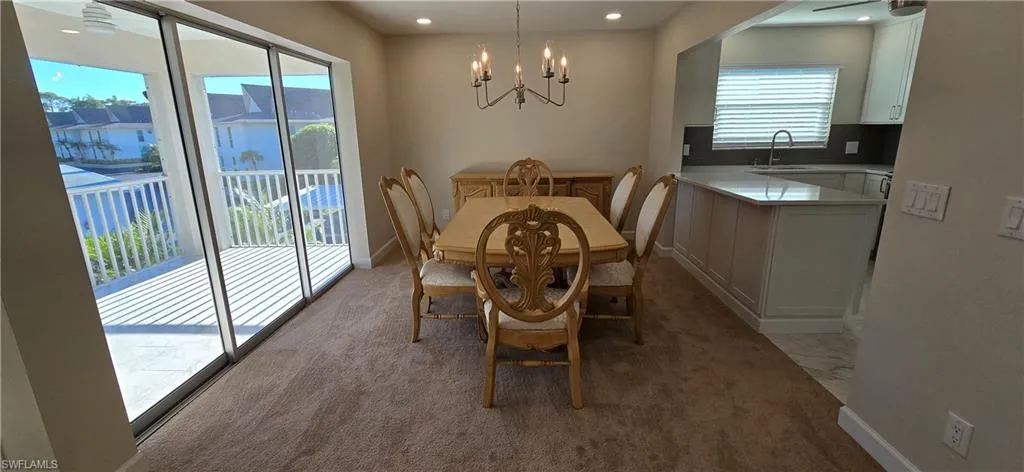 Dining area with a chandelier, and recessed lighting