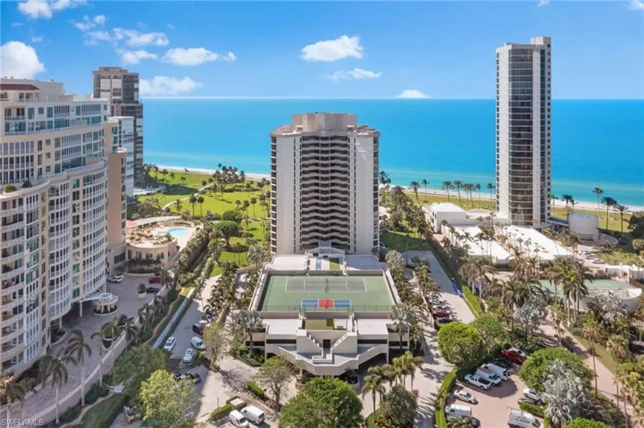 Birds eye view of property featuring a beach view and a water view