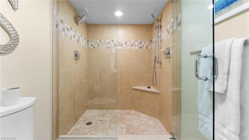 Primary Suite Bathroom featuring walk in shower and toilet