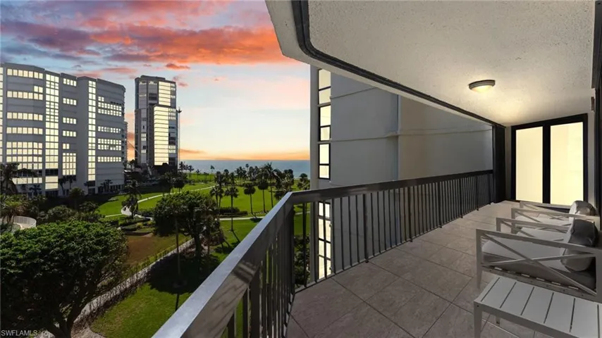 Balcony at dusk featuring a water view