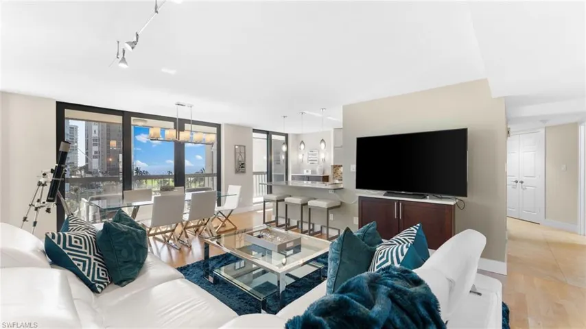 Living room featuring rail lighting and light hardwood / wood-style flooring