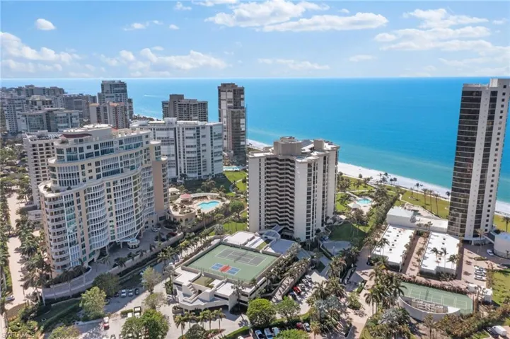 Birds eye view of property featuring a beach view and a water view