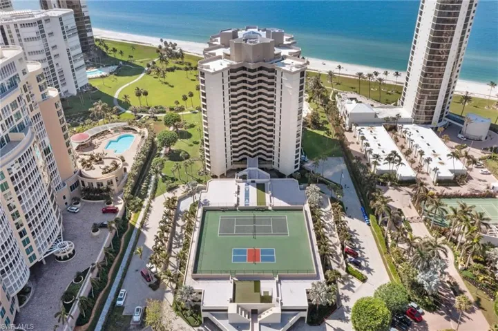 Birds eye view of property featuring a beach view and a water view