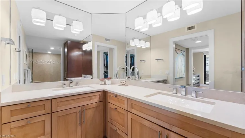 Primary Suite Bathroom with vanity and a shower with shower door