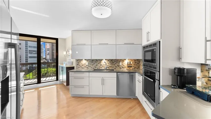 Kitchen featuring white cabinetry, appliances with stainless steel finishes, sink, and light hardwood / wood-style floors