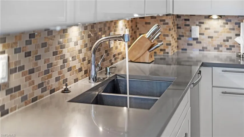 Details featuring tasteful backsplash and white cabinets