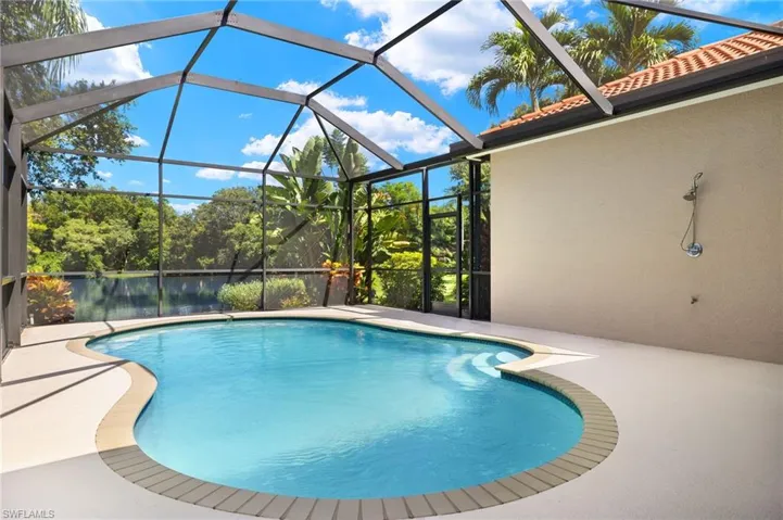View of swimming pool featuring a patio area and a lanai