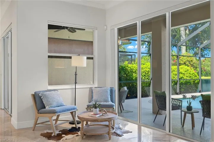 Sitting room featuring crown molding, light tile patterned floors, and ceiling fan