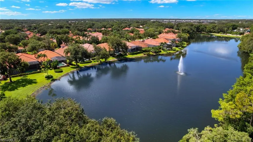 Birds eye view of property with a water view