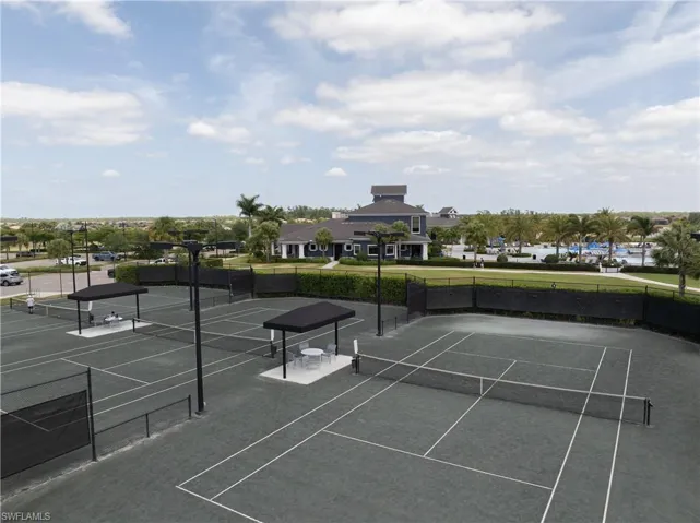 View of tennis court featuring fence