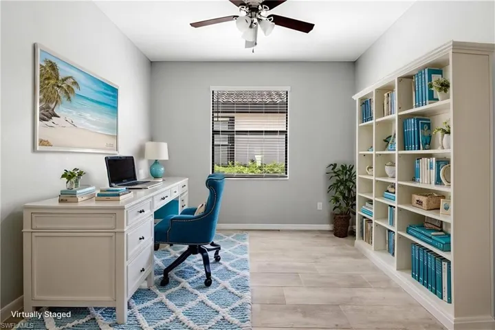 Office space featuring a ceiling fan and baseboards