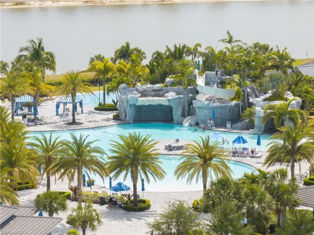 Community pool with a water play area, a water slide, and a water view