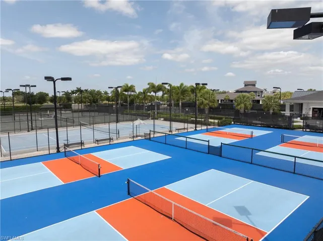 View of sport court featuring fence, community basketball court, and a tennis court
