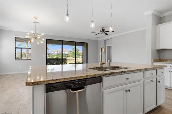 Kitchen with dishwasher, white cabinetry, ornamental molding, and a sink