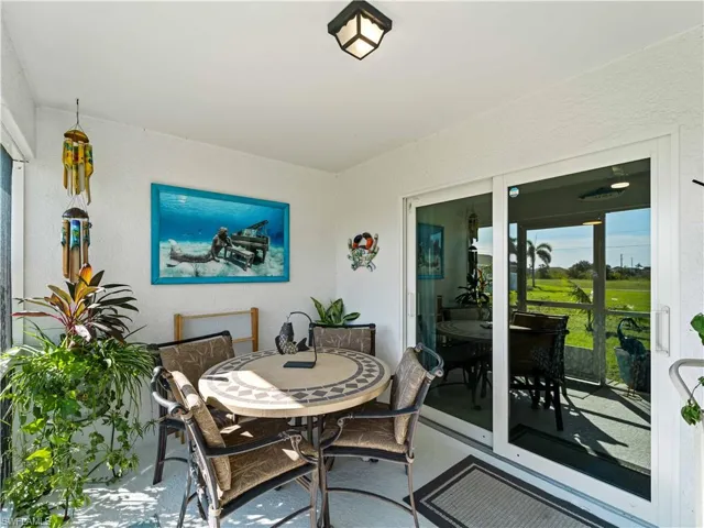 Sunroom featuring outdoor dining area