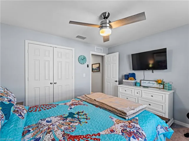Bedroom with a ceiling fan, a closet, and carpet floors