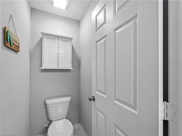 Bathroom featuring toilet and baseboards