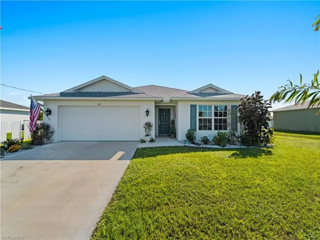 Ranch-style house with stucco siding, concrete driveway, a garage, and a shingled roof