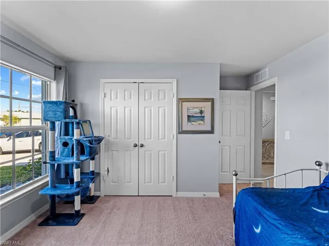Bedroom with carpet and a closet