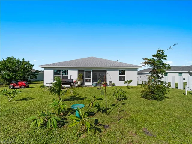 Rear view of property with a sunroom and stucco siding