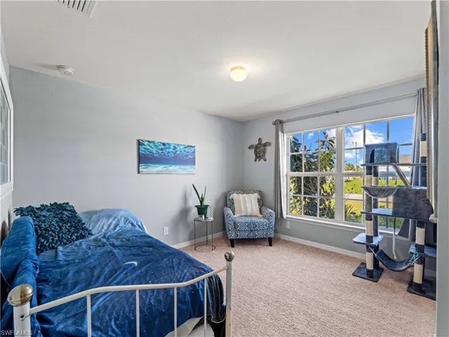 Bedroom featuring carpet and a textured ceiling